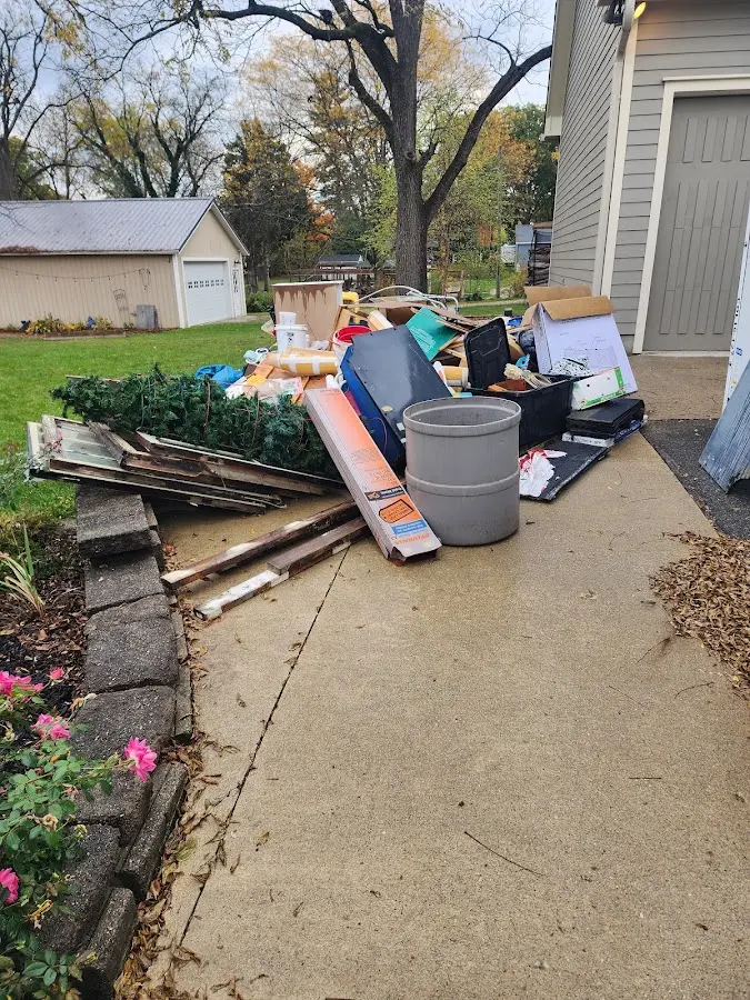 Dumpster being loaded with debris for Demolition Dumpster Rental in Sheffield Lake